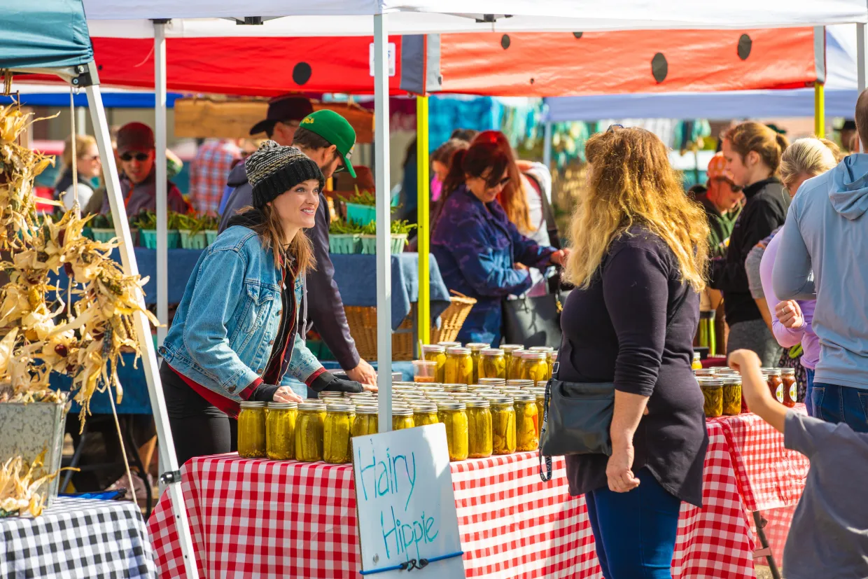 A vendors talks with a customer at a stall