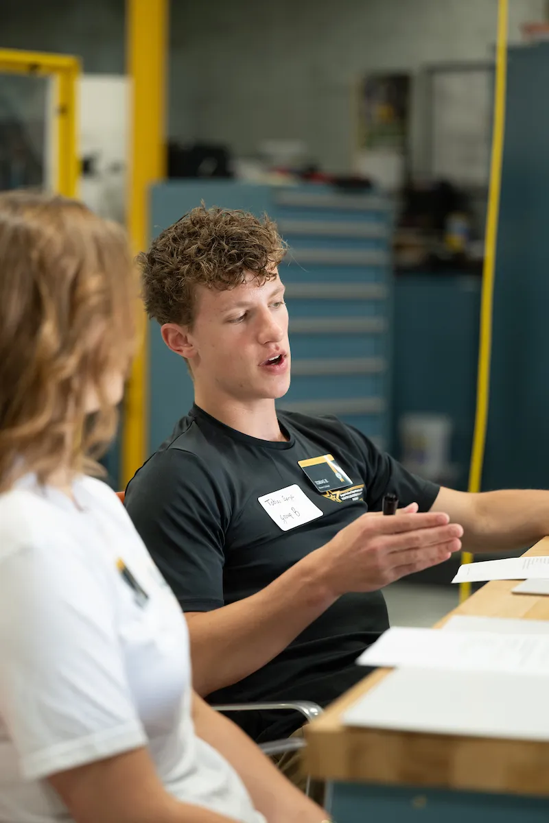 NDSU Honors College student Tobias Berge talking to another member of the cohort.