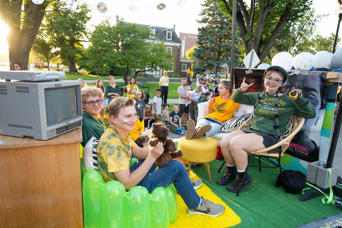 NDSU students atop a float featuring Y2K accessories at Homecoming 2025.