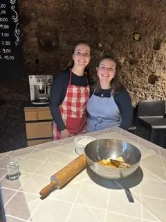 two students in side by side in a kitchen