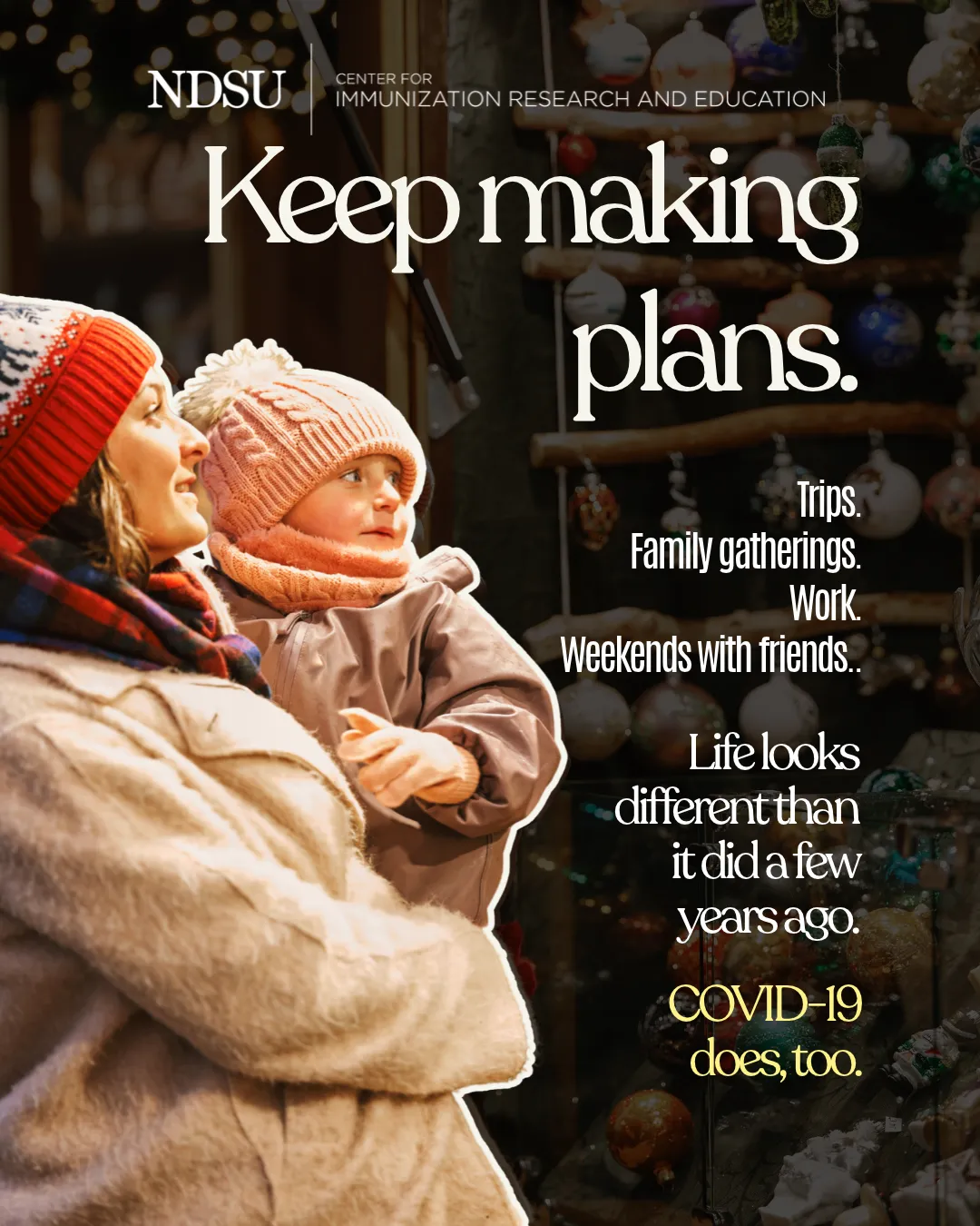 A mother holds her toddler while they look at holiday ornaments, with a message about continuing to make plans as COVID-19 changes.