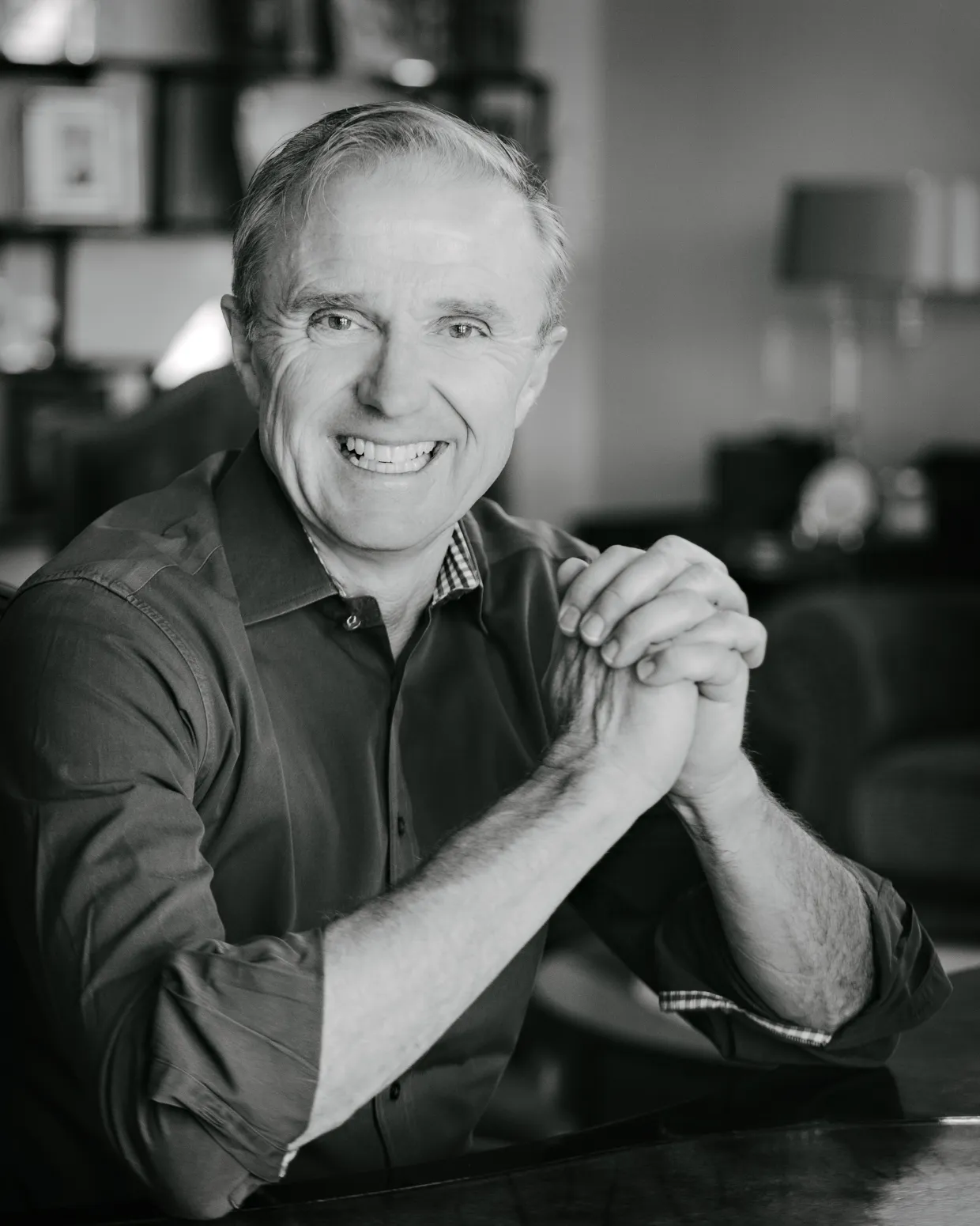 black and white photo of smiling man looking at camera