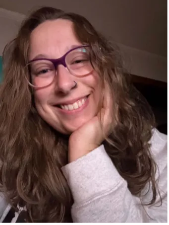 Angela smiling confidently at camera.