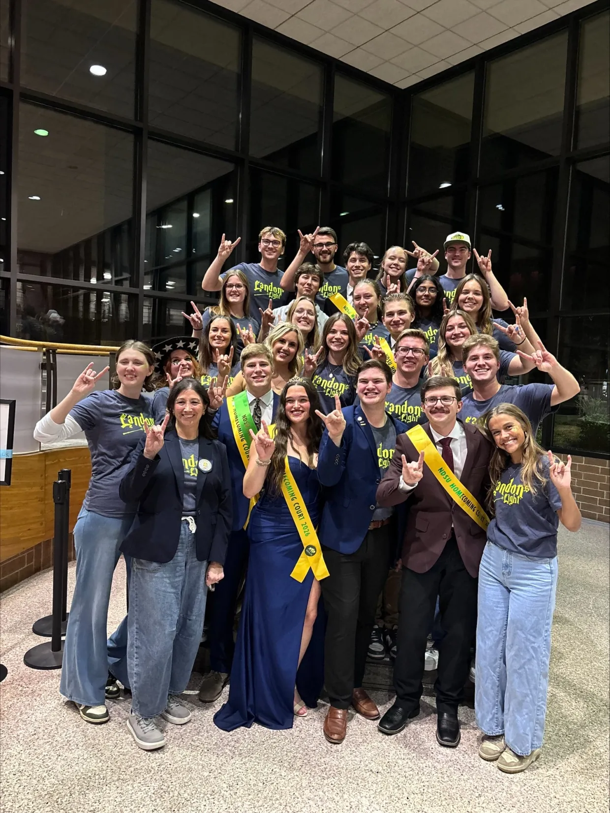 Blue Key Honor Society members and Landon's Light Foundation members put their horns up.