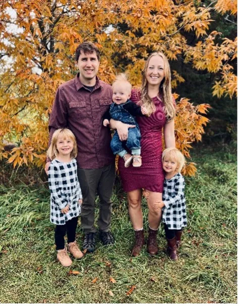 Krover family smiling confidently at camera.