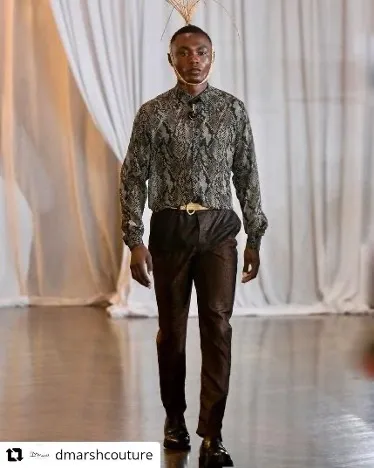 Man walking toward camera modeling designer clothes.