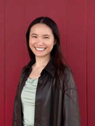 Yuan smiling confidently at camera.