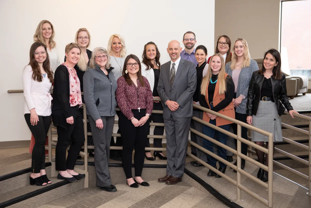 A group of people posing for a photo in a stairwell
