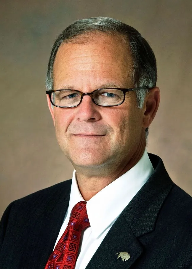 Bresciani smiling confidently at camera