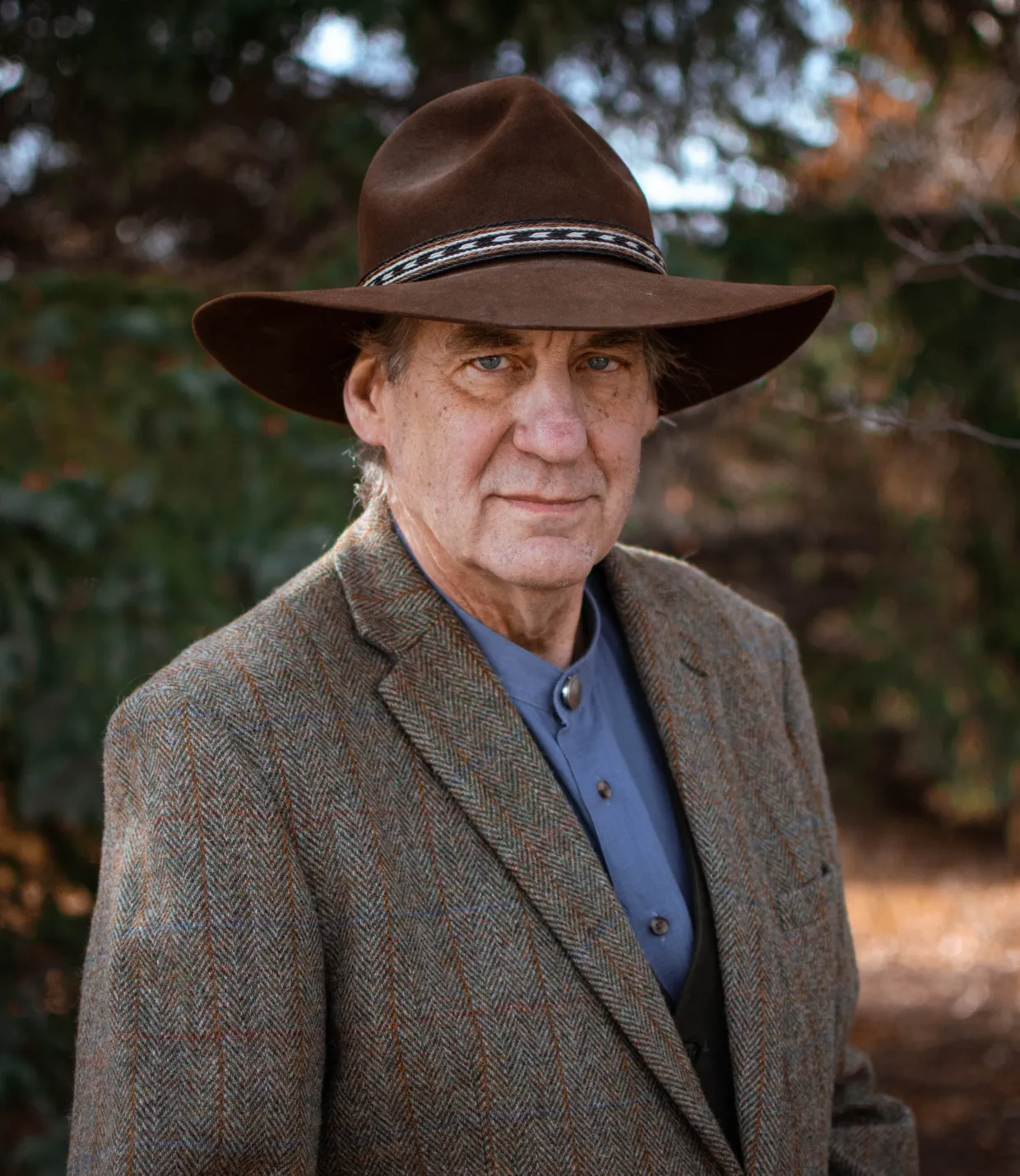 Prof. Tom Isern, in a cowboy hat and brown jacket