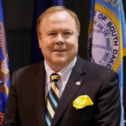 Tim Flakoll smiling confidently at camera.