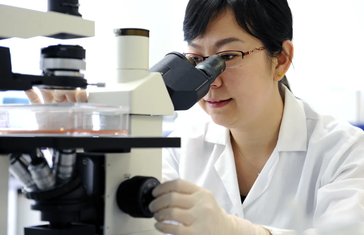 Image of student with microscope