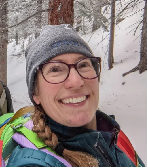 Andrea smiling confidently at camera.