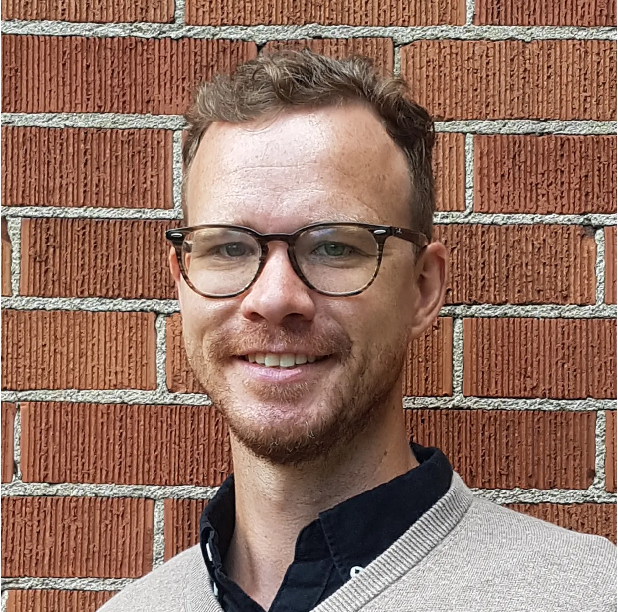 Barney Geddes smiling confidently at camera.