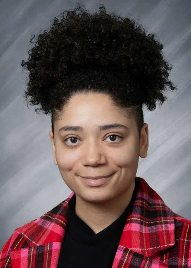 Korie DeBardlabon smiling confidently at camera.