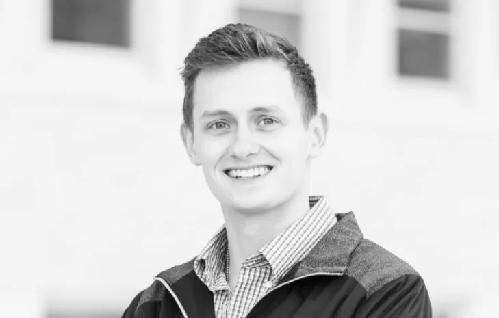 Evan Lecy smiling confidently at camera.