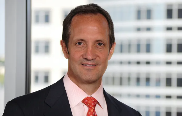 Doug Wild smiling confidently at camera. 