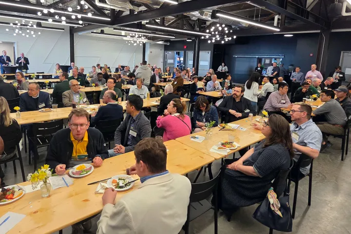 A group of approximately 150 people sitting at tables at the RCA Celebration of Research and Creative Activity event.