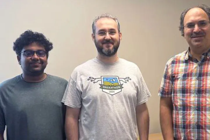NDSU assistant professor of industrial and manufacturing engineering Harun Pirim and two students