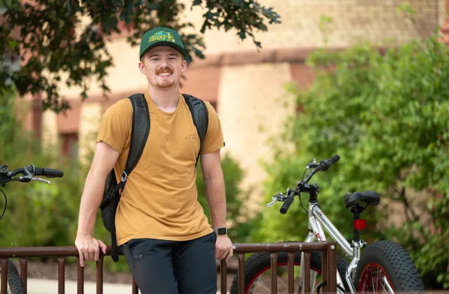 Student sitting on bike rack