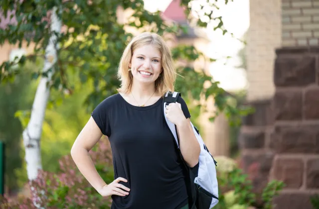 Student standing with backpack