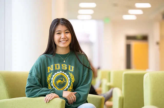 Sarah Kruse posing in a campus building