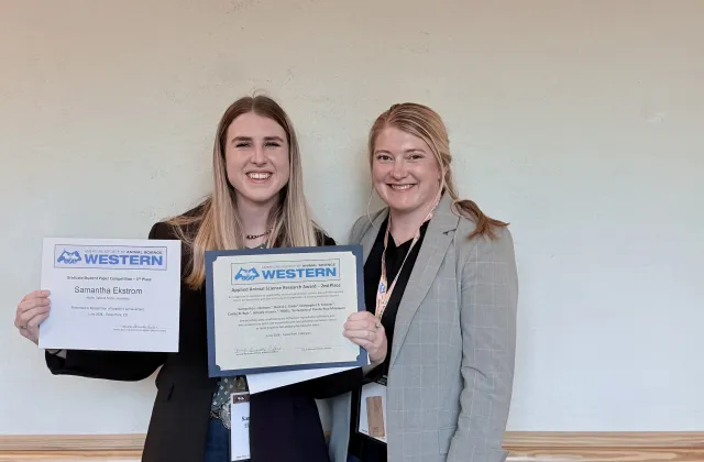 Grad student shows off awards.