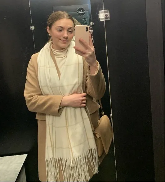 Student taking a selfie in front of mirror.