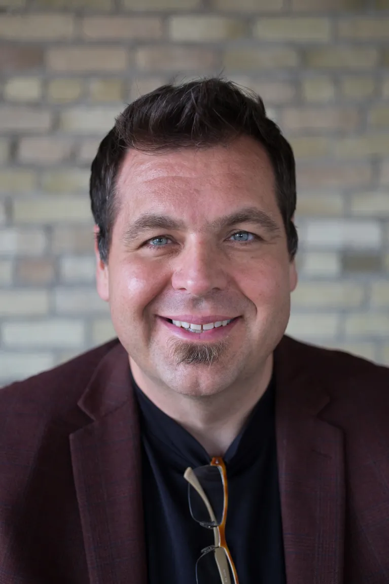 Strand smiling confidently at camera