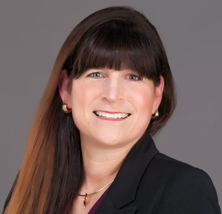 Susan Schaefer Kliman smiling confidently at camera