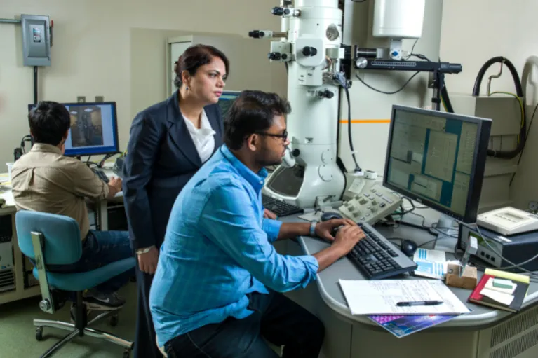 Dr. Kalpana Katti looking on as a student reviews research data