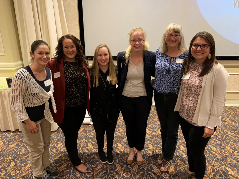 Six CIRE staff members and collaborators at a symposion