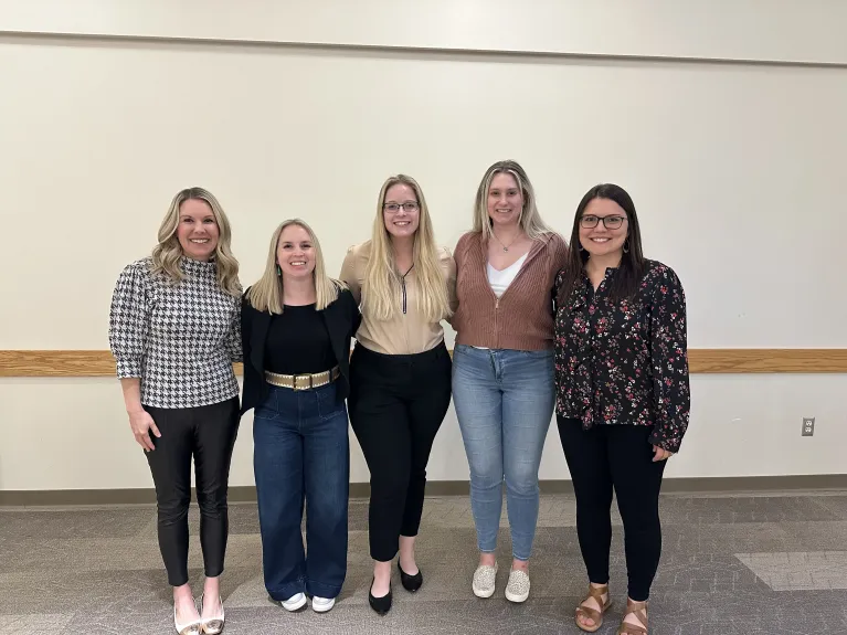 Five CIRE staff members posing in front of a white background