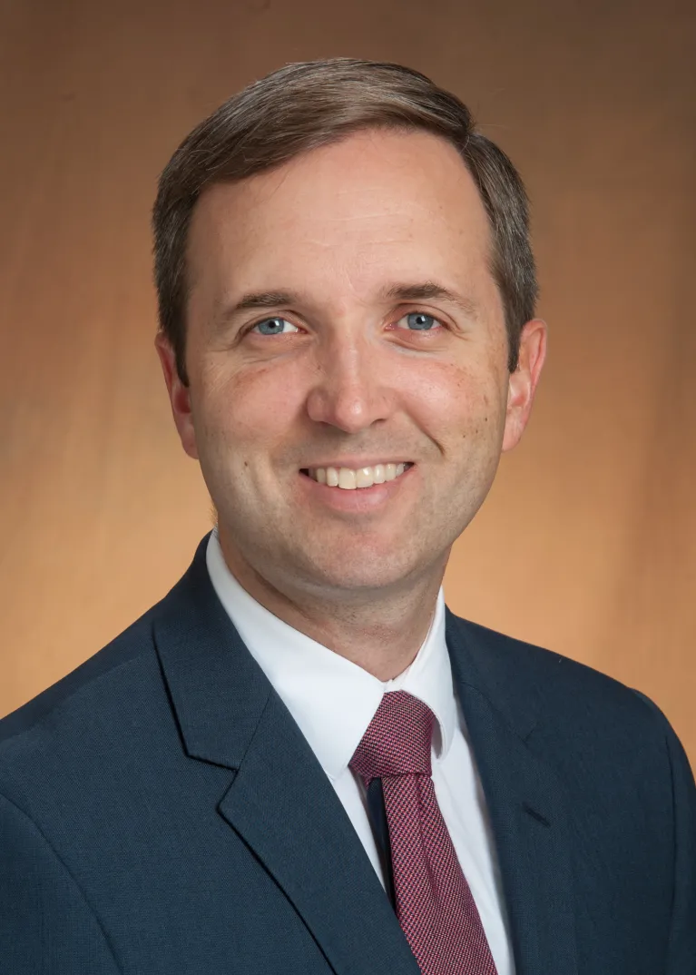 Beck smiling confidently at camera