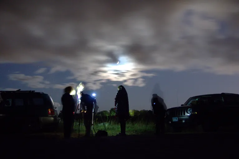 Students out at night working with camera.
