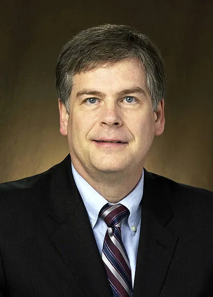 Webster smiling confidently at camera