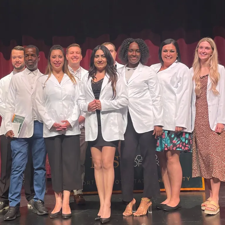 Image of nursing students in white coats