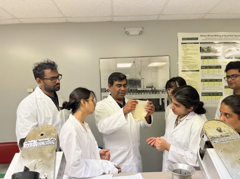Dr. SHahidul Islam showing the window-pane structure of dough to students during lab demonstration