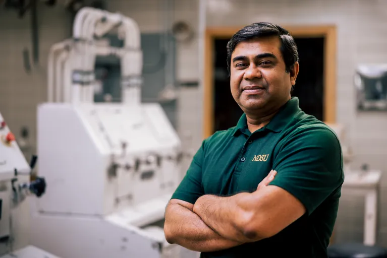 Dr. Shahidul Islam photo in front of a lab wheat mill
