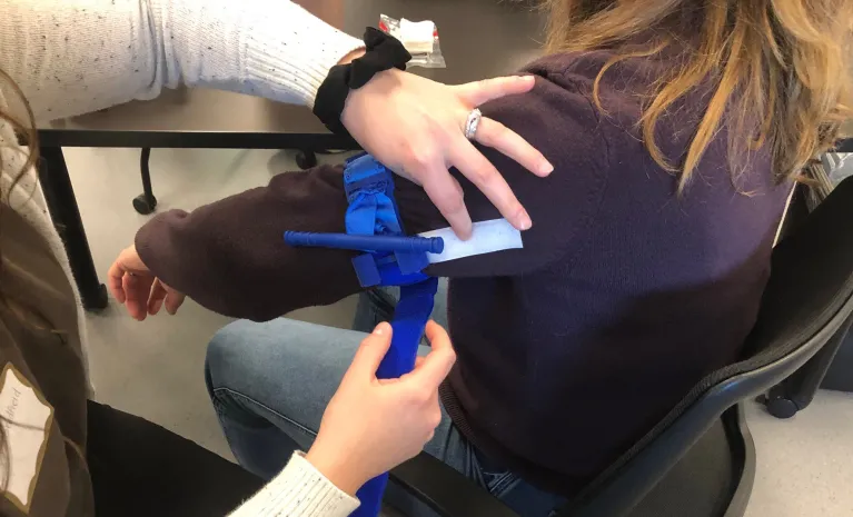 Nurse applying tourniquet