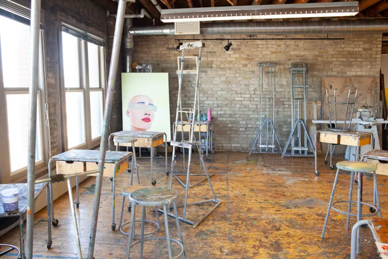 Stools, easels and canvas in painting studio.