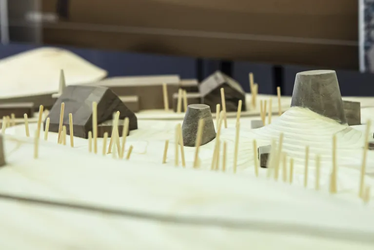 Woodshop model with buildings and sticks.