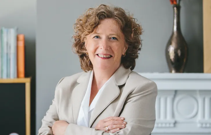 Joan Floura smiling confidently at camera.