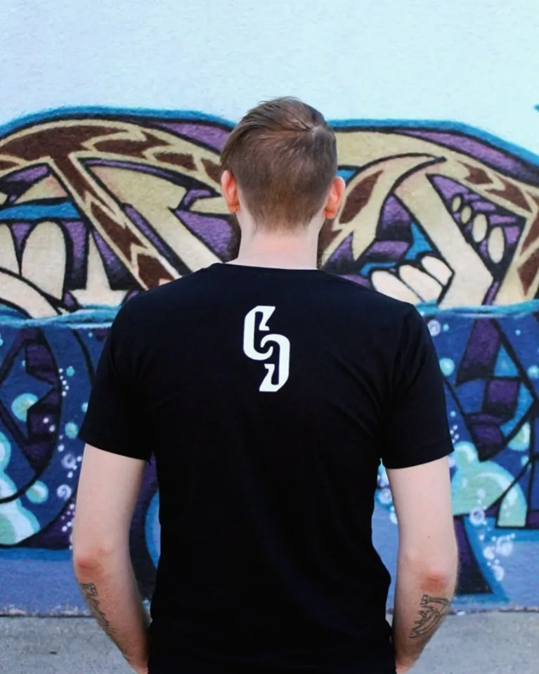 Model wearing black t-shirt with CG on back