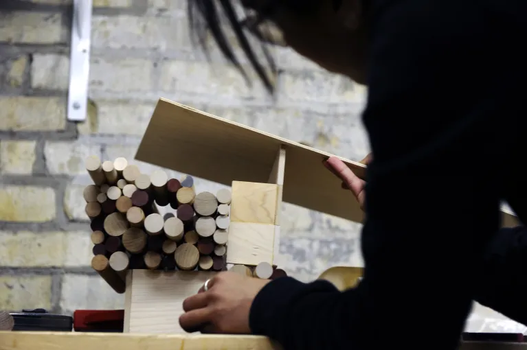 Student working with wood in woodshop.