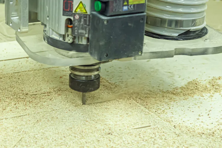 Machine cutting wood in the woodshop.