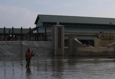Brent Hanson measuring the amount water flowing out of the Red River’s channel at the USGS ADVM gaging station at Grand Fork, ND