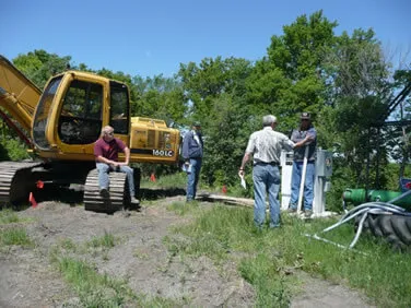 Kyle Horntvedt and NDSU-ABEN Technician Dongqing Lin finished setting up one of four wireless weather stations in a research field.